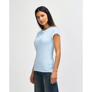 A light blue Gildan Softstyle ladies' T-shirt displayed on a model, featuring a round neckline and short sleeves.