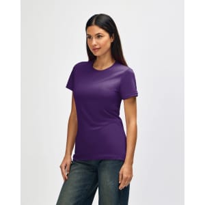 A Gildan Softstyle ladies' T-shirt in purple, featured on a model, displayed from the side with casual jeans.