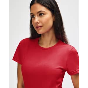 A red Gildan Softstyle ladies' t-shirt displayed on a model with a plain background. It features a logo on the shirt.