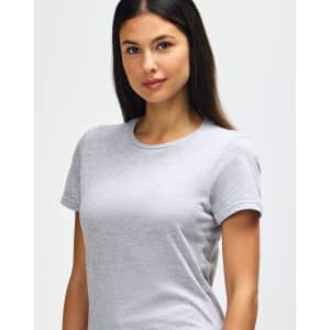 A grey Gildan Softstyle Ladies' T-Shirt displayed on a model, featuring a casual fit and short sleeves.
