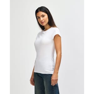 A fitted white ladies' T-shirt displayed on a model, paired with blue denim jeans. The shirt has a logo.