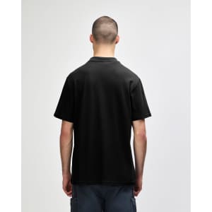 A black adult polo shirt with a double pique design, featuring short sleeves and a collar. There is a logo on the shirt.