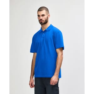 A man models a royal blue Gildan Softstyle Adult Double Pique Polo, featuring a logo on the left side.