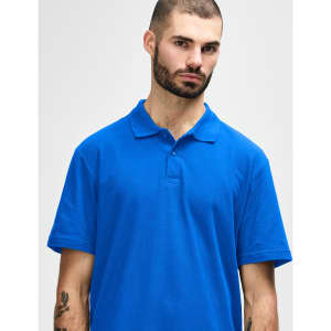 A blue Gildan Softstyle adult double pique polo shirt on a model, featuring a collar and buttons, with a logo.