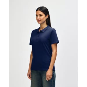 A navy blue ladies' polo shirt is displayed on a model, featuring a collar and short sleeves. It has a logo.