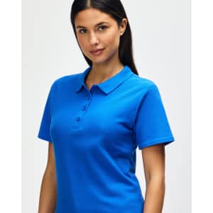 A woman smiles while wearing a blue Gildan Softstyle Ladies' Double Pique Polo with a collar and buttons.