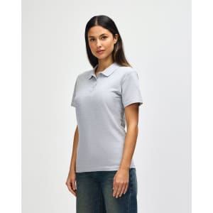 A light grey ladies' polo shirt with short sleeves and a collar, featuring a logo on the chest.