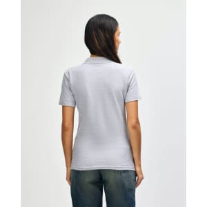 A grey ladies' polo shirt with a soft pique texture, featuring a simple design and a branding logo on the back.