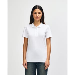 A woman wearing a white Gildan Softstyle Ladies' Double Pique Polo with a classic collar. The polo features a logo.