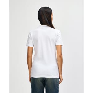 A white ladies' polo shirt with short sleeves, featuring a logo on the back, paired with blue jeans.
