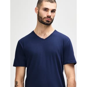 A navy Gildan Softstyle adult v-neck t-shirt displayed on a model with short sleeves. The garment has a logo.