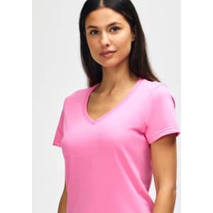 A pink Gildan Softstyle ladies' V-neck T-shirt displayed on a model, featuring a fitted design.
