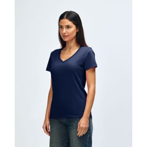 A navy Gildan Softstyle ladies' V-neck T-shirt displayed on a model, with a simple and minimalist design.