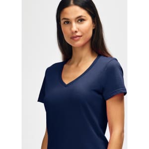 A navy Gildan Softstyle ladies' V-neck T-shirt displayed on a model, featuring a fitted design and short sleeves.