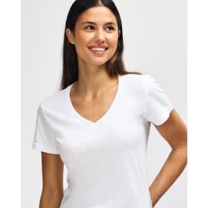 A white Gildan Softstyle ladies' v-neck t-shirt displayed on a model, featuring a fitted design and short sleeves.