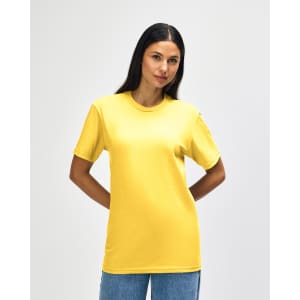 A yellow midweight T-shirt worn by a model, featuring a logo on the garment.