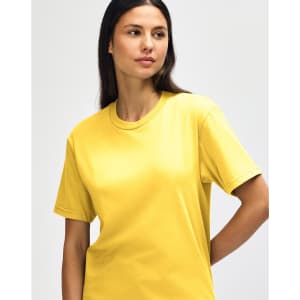 A yellow Gildan Softstyle adult midweight t-shirt on a model, featuring short sleeves and a casual fit.