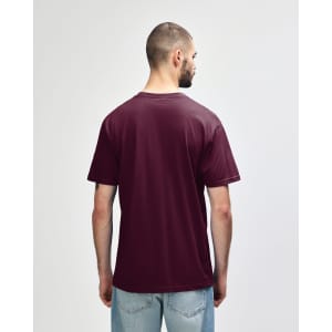 A person wearing a maroon Gildan Softstyle Adult Midweight T-Shirt, viewed from the back. The shirt has no visible logos.