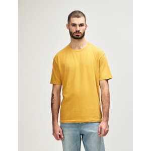 A midweight adult t-shirt in mustard yellow with a fitted style, featuring a logo.
