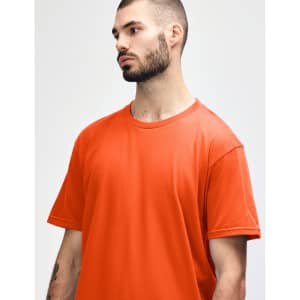An orange Gildan Softstyle adult midweight t-shirt worn by a model. The shirt has a round neckline and short sleeves.