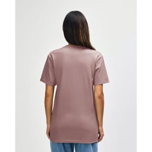 A midweight t-shirt in a muted pink shade, featuring a plain back and short sleeves. It has a branding logo.