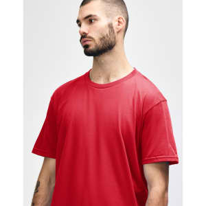 A red midweight t-shirt on a model, featuring a round neckline and short sleeves, displaying a minimalist design.