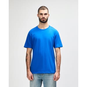 A blue Gildan Softstyle adult midweight T-shirt displayed on a model, featuring a simple design and short sleeves.