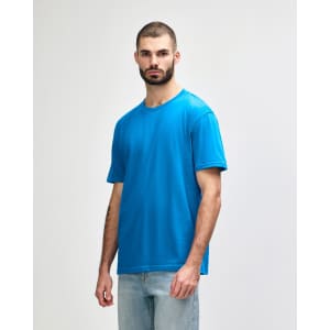A blue Gildan Softstyle adult midweight t-shirt featured on a model against a plain background.