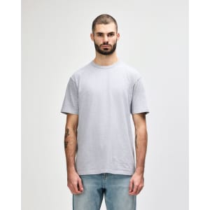 A grey Gildan Softstyle adult midweight T-shirt displayed on a male model, featuring a simple design and a logo.