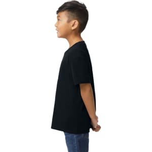 A black Gildan Softstyle youth midweight T-shirt displayed on a child, viewed from the side.