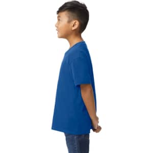 A blue Gildan Softstyle youth midweight t-shirt viewed from the back, worn by a child. The shirt has a logo.