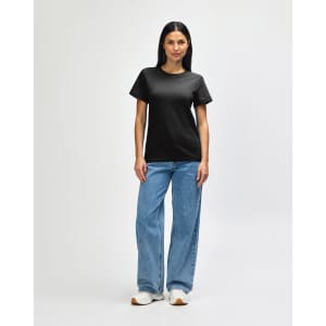 A black Gildan Softstyle ladies midweight T-shirt paired with blue jeans and white sneakers, featuring a logo.
