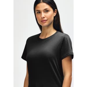 A black Gildan Softstyle ladies midweight T-shirt displayed on a model, featuring a crew neckline and short sleeves.