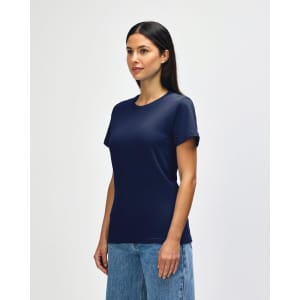 A navy Gildan Softstyle ladies midweight T-shirt displayed on a model, featuring a simple design and a logo.