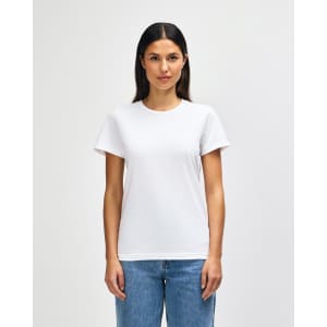 A white midweight t-shirt for ladies, featuring a classic fit and short sleeves. The model is wearing jeans.