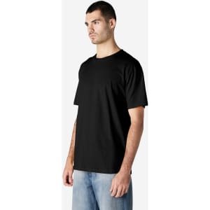 A black Gildan Softstyle adult enzyme wash t-shirt on a model, featuring short sleeves and a relaxed fit.