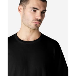 A black Gildan Softstyle adult enzyme wash no-label T-shirt displayed on a male model.