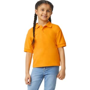 An orange Gildan youth polo shirt displayed on a girl with braided hair, smiling against a white background.