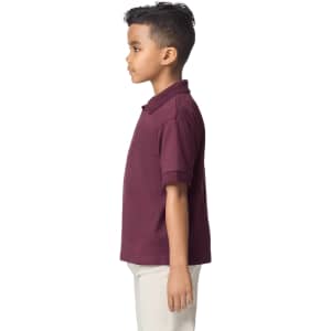 A youth polo shirt in burgundy, featuring a collar and short sleeves, shown on a child from the side.