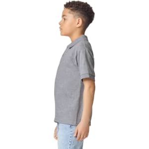 A grey Gildan youth polo shirt displayed on a model, featuring short sleeves and a logo on the chest.