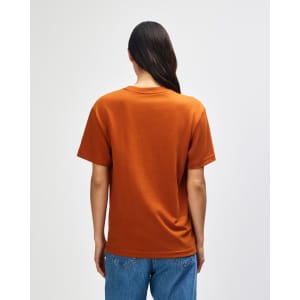 A man wearing an orange American Apparel Super Heavyweight T-Shirt, viewed from the back, with short sleeves.