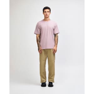 A model wearing a purple heavyweight t-shirt with relaxed-fit olive cargo pants and white sneakers.