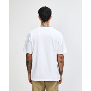 A white American Apparel Super Heavyweight T-Shirt viewed from the back, worn by a model with curly hair.