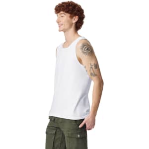 A white adult tank top displayed on a model with red curly hair and a tattoo on his arm.