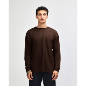 A brown Super Heavyweight T-shirt featuring long sleeves and a chest pocket, with a simple logo on the side.
