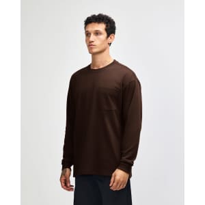 A brown long-sleeve t-shirt featuring a pocket and a branding logo.