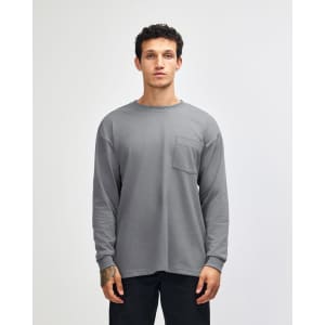 A grey long-sleeve t-shirt with a chest pocket, featuring a logo on the label.