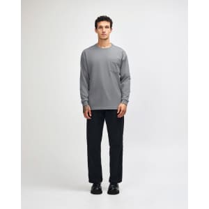 A model wears a grey long-sleeve t-shirt paired with khaki cargo pants and sneakers.