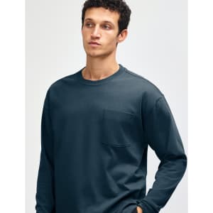 A long-sleeve super heavyweight t-shirt in dark teal, featuring a single chest pocket and a crew neckline.