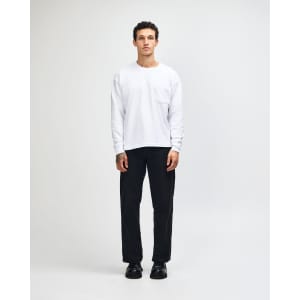 A model wearing a white American Apparel Super Heavyweight T-Shirt paired with olive green cargo pants.